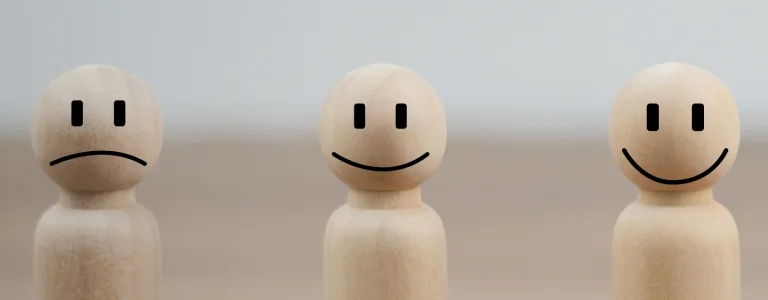 a wooden figure with a smiley face

