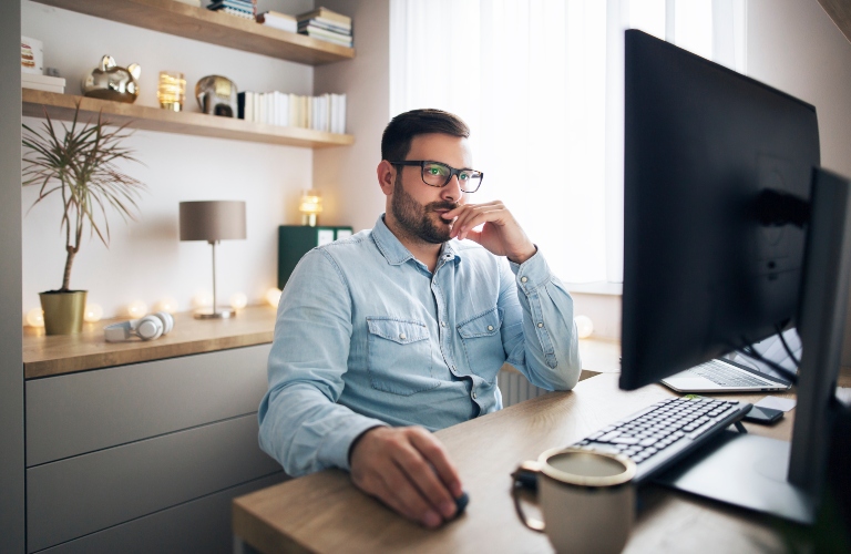 man with glasses browsing information on the Internet