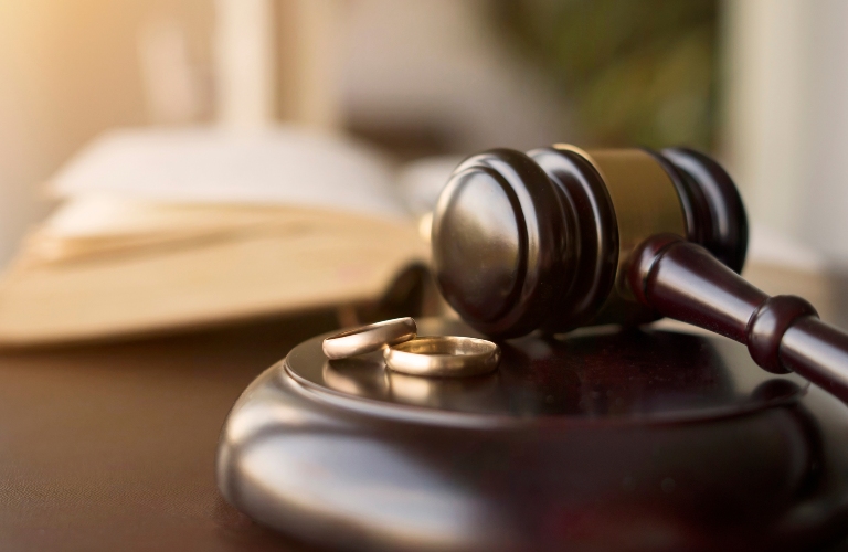 Judge gavel and wedding rings for divorce proceedings
