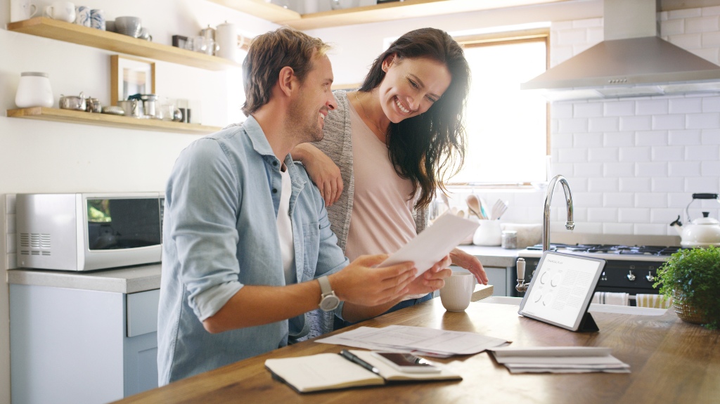 happy сouple with documents at home