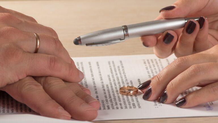 Wife and husband signing divorce documents