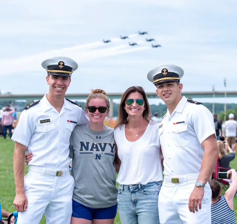 Four people in military parade, including two military members and two attorney, posing for the photo.