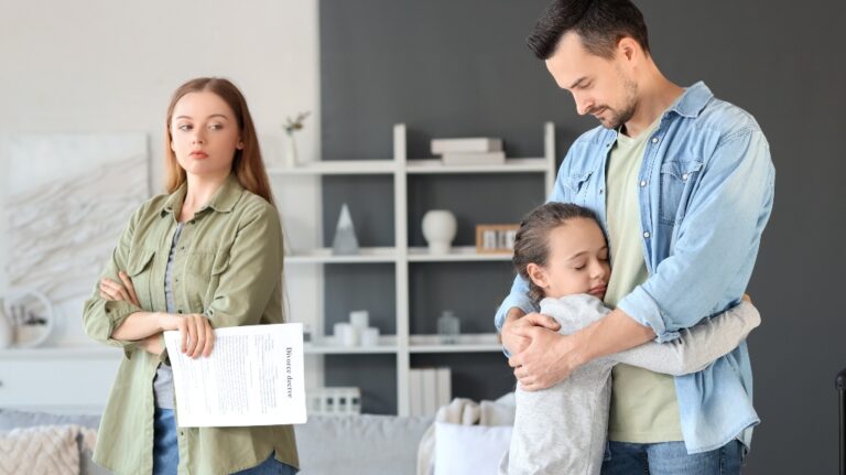 Little girl hugging her father after divorce at home