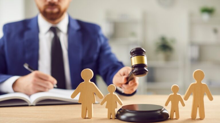 wooden family figures and judge gavel