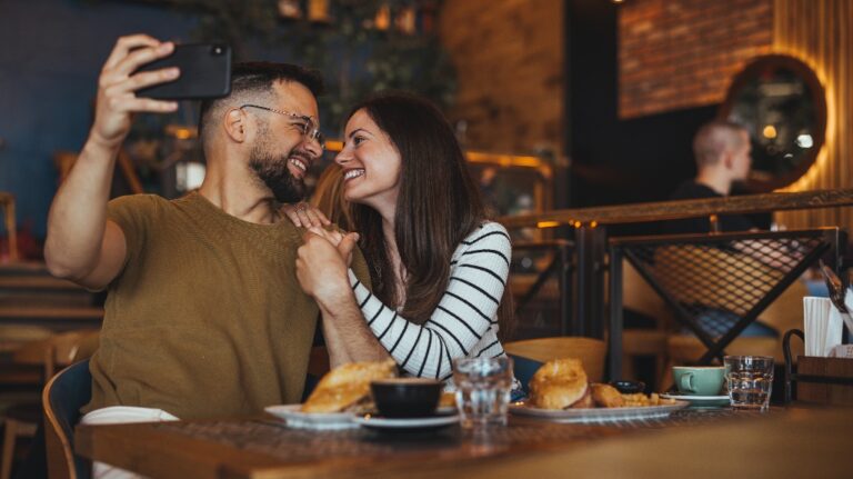 Couple engages in taking a selfie with a smartphone