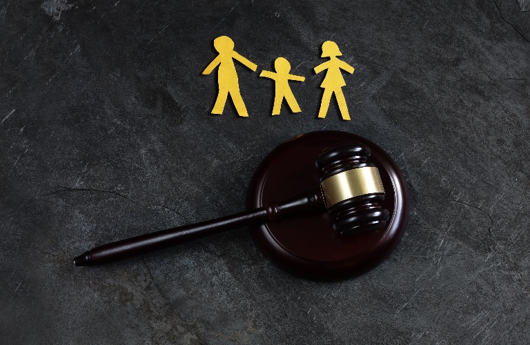 Paper family of three with judge's gavel