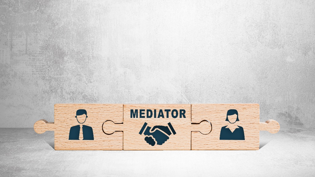 Wooden puzzle with icons of a man, mediator and woman