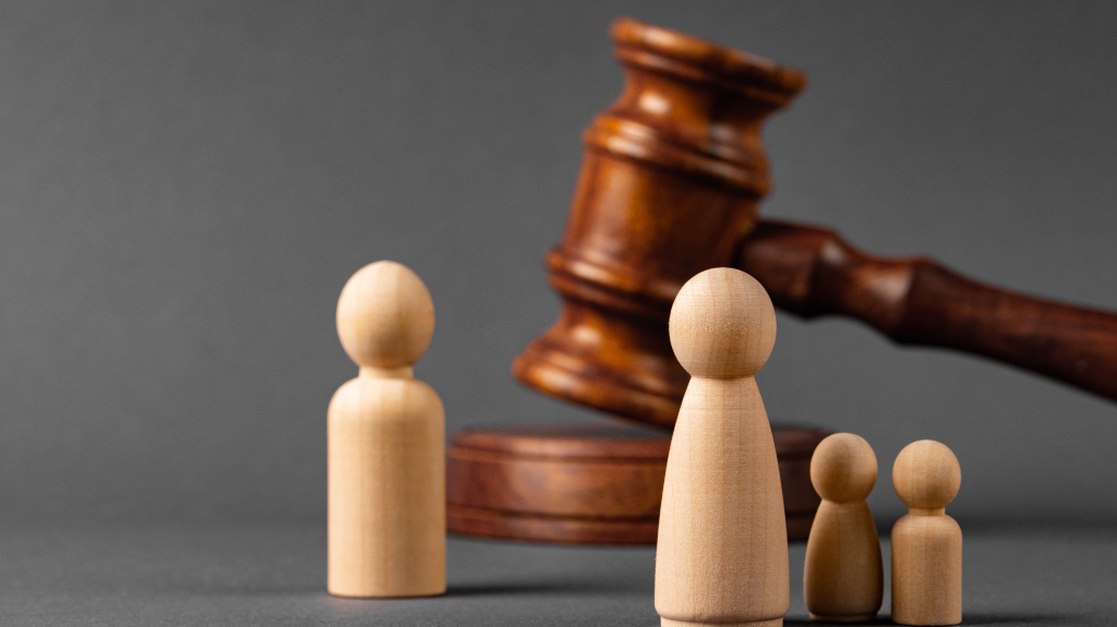 Wooden toy family and judge's gavel