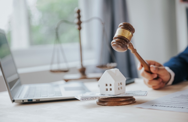 judge's gavel and small wooden toy house