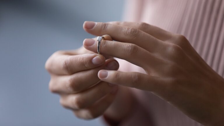 young woman takes off wedding ring