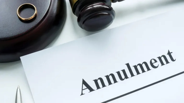 Close-up of a legal document titled "Annulment" with a wooden gavel and wedding ring.