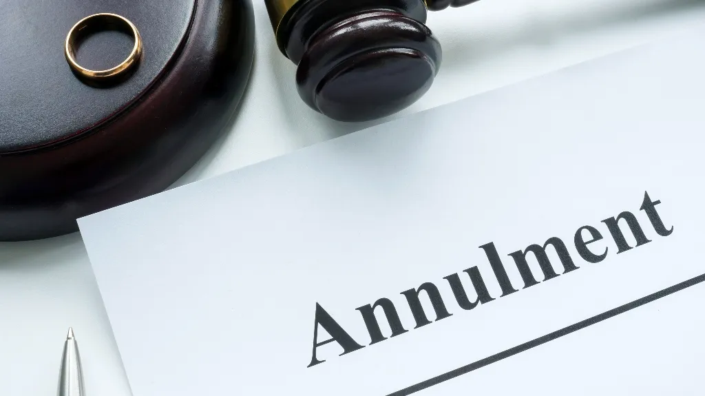 Close-up of a legal document titled "Annulment" with a wooden gavel and wedding ring.